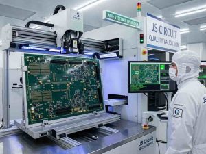 20-Layer Backplane Design for AI Servers: Meeting the AI Compute Surge | JS Circuit INC 20-Layer Backplane Design for AI Servers:The focus is on a sophisticated automated optical inspection (AOI) robotic arm utilizing blue LED sensor arrays to analyze a newly fabricated, ultra-dense 20-layer backplane circuit panel meant for AI server clusters.